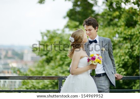 Happy bride and groom enjoying themselves in a park