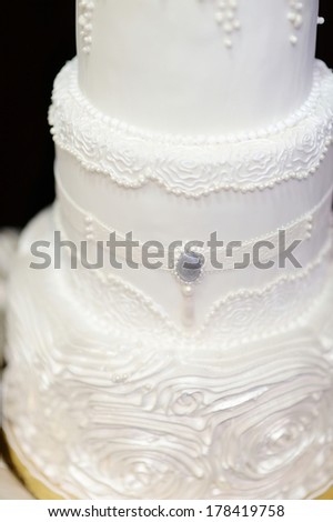White wedding cake decorated with white icing