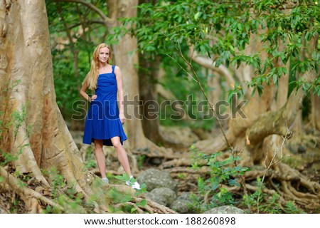 Young beautiful woman in a tropical jungle