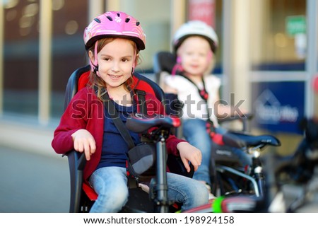 Two little sisters ready to ride a bicycle