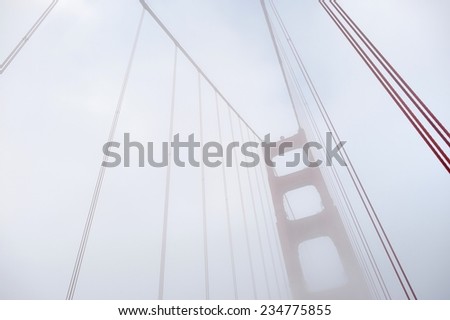 World famous Golden Gate Bridge covered by fog after in San Francisco