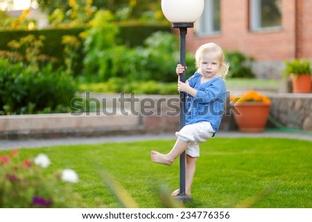 Cute little girl having fun running and laughing on a sunny summer day