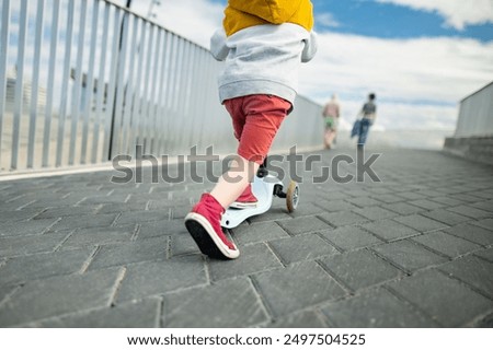 Similar – Image, Stock Photo Little kid riding his bike down
