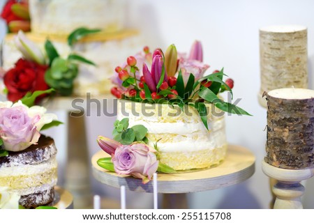 White wedding cake decorated with natural flowers