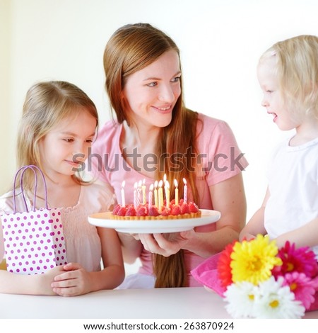 Two little daughters wishing their mother a happy birthday