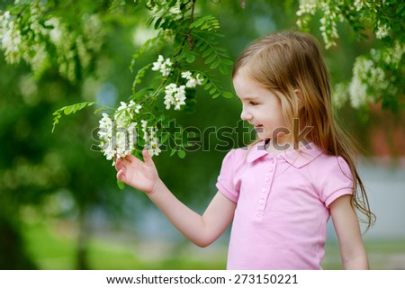 Cute little girl enjoying herself on hot and sunny summer day