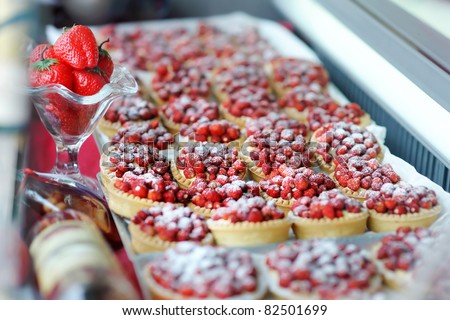 Mini strawberry tarts on a cake shop