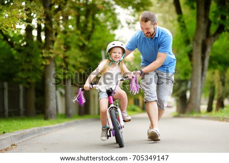 Similar – Image, Stock Photo Little kid riding his bike down