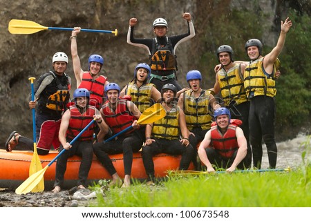 LARGE GROUP OF YOUNG PEOPLE READ TO GO RAFTING