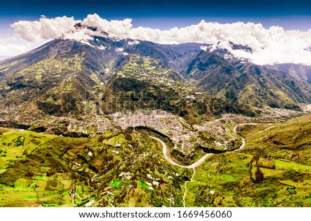 aerial shot of banos de agua santa nne to ssw tungurahua volcano in the background and pastaza river in foreground volcanoe vulcan building canyon vacation earth dynamic outdoor exploration ecuador ex Stock fotó © 