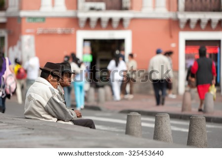 Quito, Ecuador - 21 December 2011: Two Old Men Watching The People Passing By On The Streets Of Quito Ecuador Capital In Quito On December 21, 2011