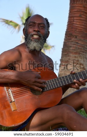 OLD BLACK MEN PLAYING GUITAR ON A TROPICAL ISLAND