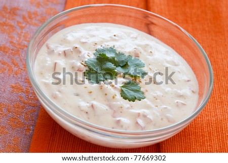 Indian yogurt dip with tomatoes and cilantro which is also called raita.