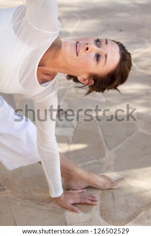 A flexible middle age senior woman doing yoga