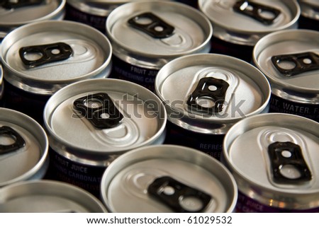 Row of soda cans with black ring pulls