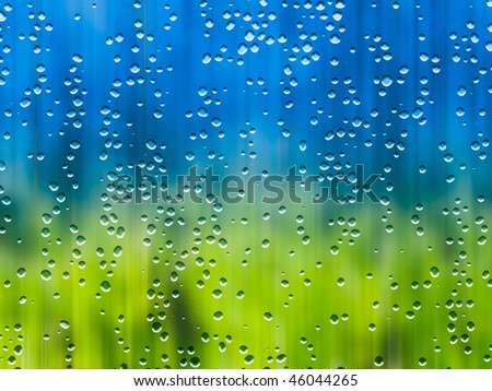 Rain during sunshine, sunshower and drops on the window