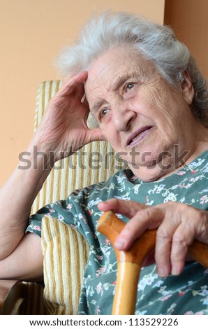 portrait of a hopeful senior woman holding a cane
