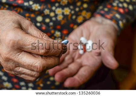 hand picking pill from palm