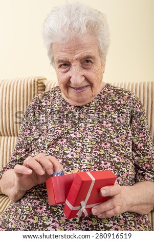 senior woman opening gift