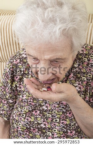 ill senior woman taking pills