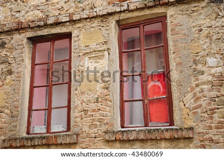 red flag on window - stone wall
