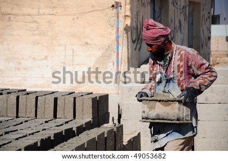 A brick layer worker building a brick