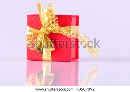 red gift box with its reflection