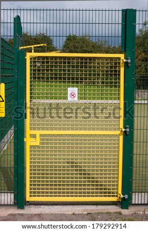 Sports field gate with no dogs sign