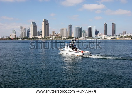 A San Diego skyline and a patrol boat in the bay.