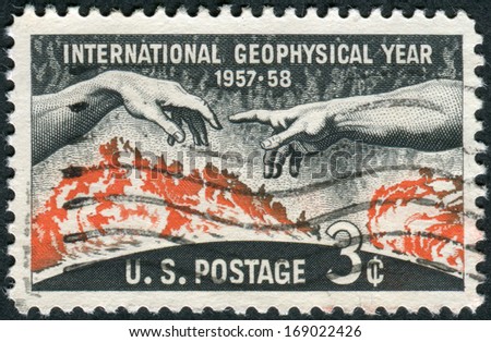 USA - CIRCA 1958: A postage stamp printed in the USA, dedicated Geophysical Year (IGY, 1957-58), shows Solar Disc and Hands from Michelangelo\'s \