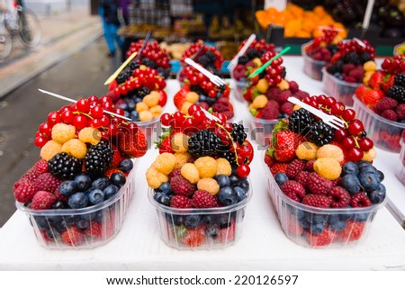 Sale of fresh berries. Focus on the foreground.