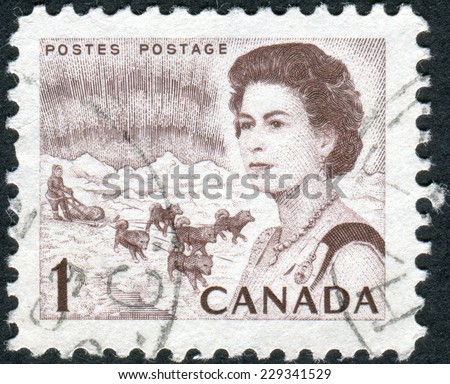 CANADA - CIRCA 1967: Postage stamp printed in Canada, shows Northern Lights and Dog Team, a portrait of Queen Elizabeth II, circa 1967