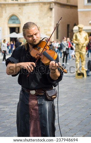 PRAGUE, CZECH REPUBLIC - SEPTEMBER 18, 2014: Performance of street musicians in medieval clothes on the Old Town Square.