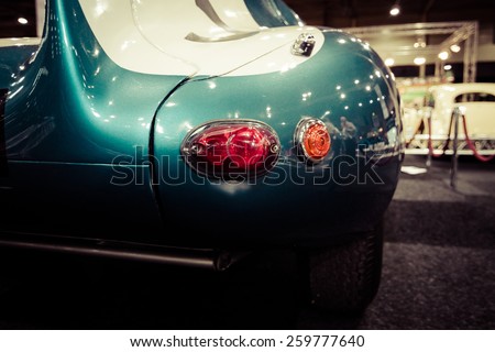 MAASTRICHT, NETHERLANDS - JANUARY 09, 2015: Stop-lights of a sports racing car Jaguar D-Type, 1956. Vintage toning. Stylization. International Exhibition InterClassics & Topmobiel 2015