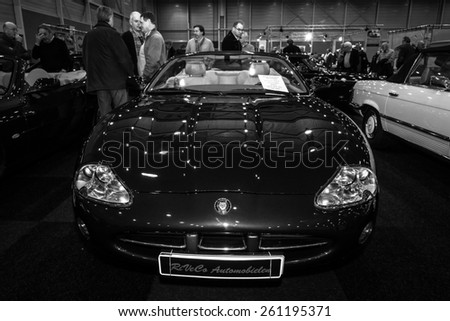 MAASTRICHT, NETHERLANDS - JANUARY 09, 2015: Grand tourer car Jaguar XK8 Convertible, 2001. Black and white. International Exhibition InterClassics & Topmobiel 2015
