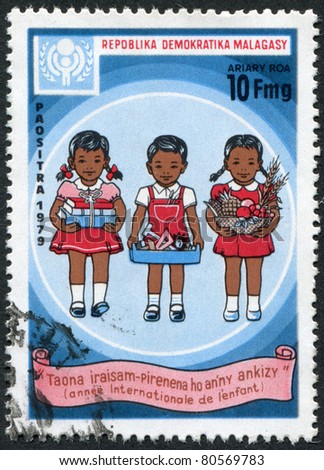 MADAGASCAR - CIRCA 1979: Postage stamps printed in Madagascar, is dedicated to International Children's Day, shows the children with books, toys, fruits, circa 1979