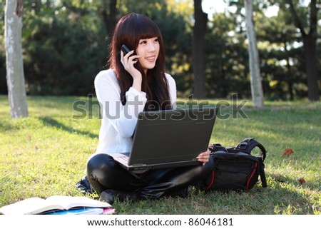 A asian student talking on the phone