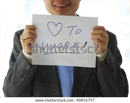 Gentleman holding a card saying Love to Work