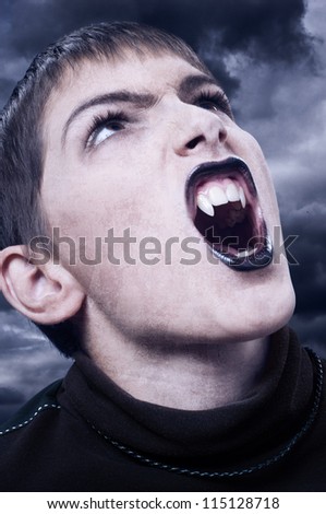 Portrait of fierce vampire with sharp long teeth on stormy night.