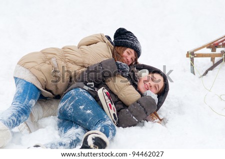 Beautiful teenage girls having fun in the snow.