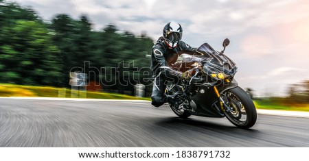 Similar – Foto Bild Motorradfahren bei Sonnenuntergang auf der leeren Straße bei einer Motorradtour. copyspace für Ihren individuellen Text.