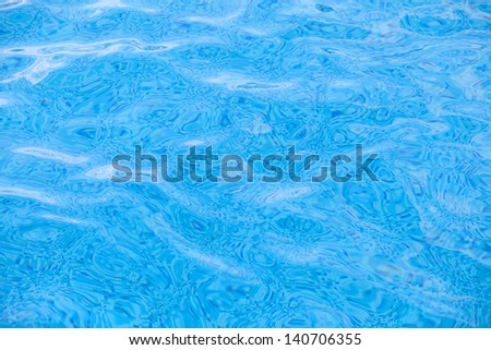 Clean water in blue swimming pool.