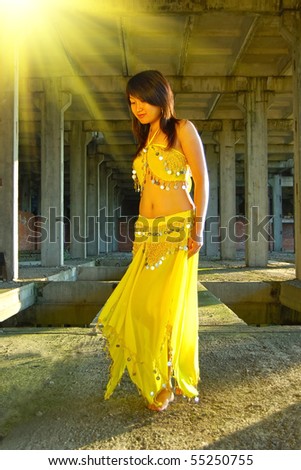 Pretty girl dancing in yellow indian dress