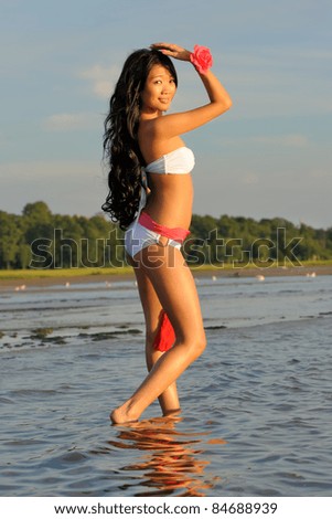 Beautiful asian woman in white bikini at sea
