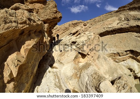 Hikers group ascending to Big Crater in Negev desert, Israel