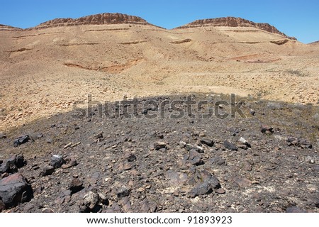 Geological formations from black lava stone in Ramon crater, Negev desert in Israel.