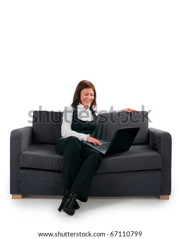 The woman the businessman has settled down on a sofa and works at the computer