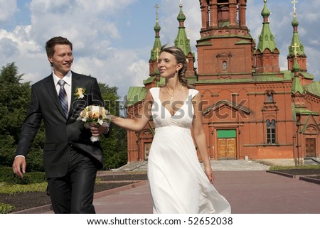 bride and the groom on a background of church