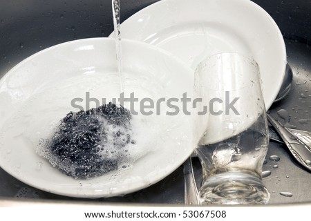 plates and glass washing in a sink
