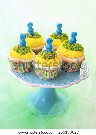 Easter cupcakes. Angel food cupcakes with yellow vanilla frosting and blue candy bunnies.